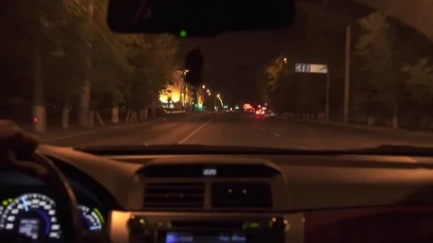 Man driving a car at night 4K Stock Footage 80418954