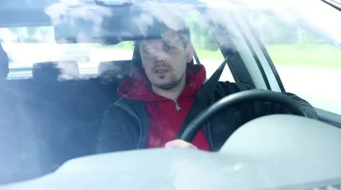 Man driving car shoot from in front of windshield Stock Footage 28959654