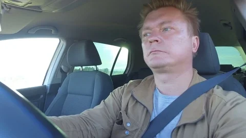 Man driving  car. Side view portrait of  male on roadtrip. Man is concentrating  Stock Footage 83765515