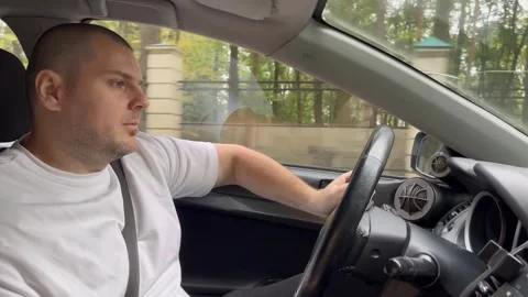 Man driving, a car with a smiling driver at the wheel, comfortable and happ.. Stock Footage 253576163