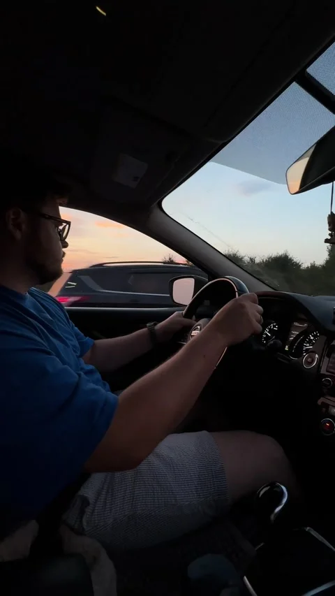 Man driving car on sunset Stock Footage 251864136