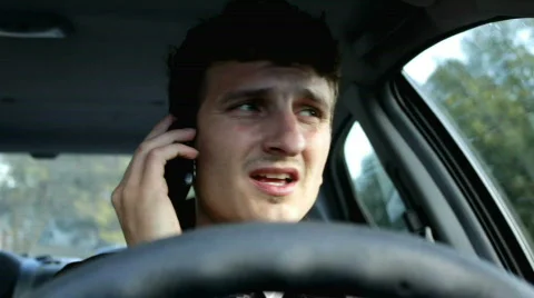 Man driving car talking on cell phone 스톡 동영상 872369