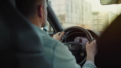 Man driving car through the streets of the city Stock Footage 301543547