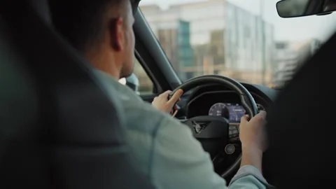 Man driving car through the streets of the city Stock Footage 301543716