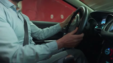 Man driving car through an underground parking lot and is looking for a place to Video stock 156850870