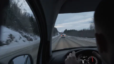 Man driving a car through the winter road Stock Footage 86644551