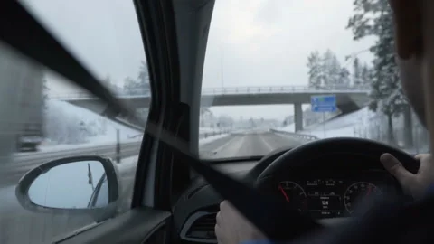 Man driving a car through the winter road Stock Footage 86647468