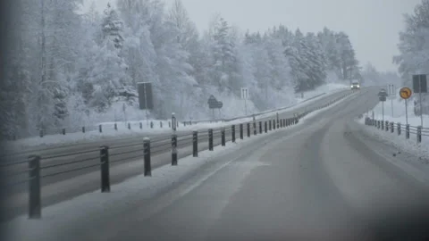 Man driving a car through the winter road Stock Footage 88651006