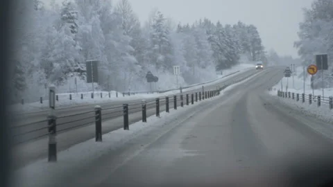 Man driving a car through the winter road Stock Footage 88651037