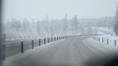 Man driving a car through the winter road Stock Footage 88651120