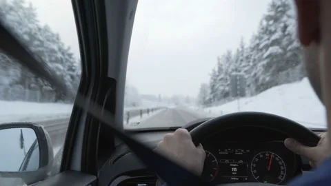 Man driving a car through the winter road Stock Footage 88651296
