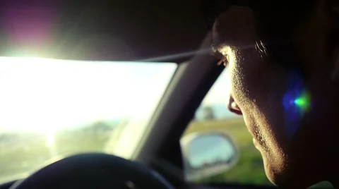 Man driving the car under sunset sky at outdoor in slowmotion. Summer time Stock Footage 61039766