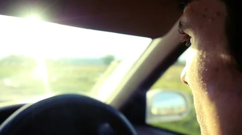 Man driving the car under sunset sky at outdoor in slowmotion. Summer time Stock Footage 61039829