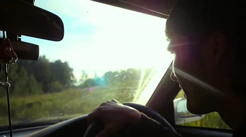 Man driving the car under sunset sky at outdoor in slowmotion. Summer time Stock Footage 61039968