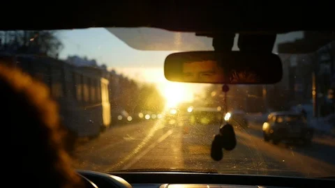 The man driving the car under sunset sky reflection in the rear view mirror Video stock 70319401