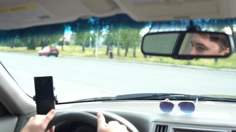 Man driving a car waiting at an intersection Video stock 94042018