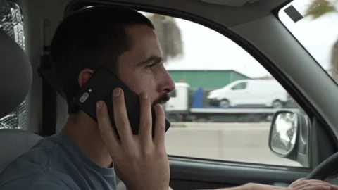 Man driving car while talking on the phone. Stock-Footage 143538594