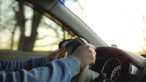 Man driving a car.man's hand on the steering wheel of a car Stock Footage 103217665
