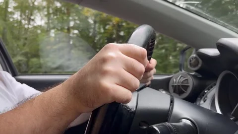 Man driving, a close-up of a driver's hands on the steering wheel, safe and.. Stock Footage 253576193