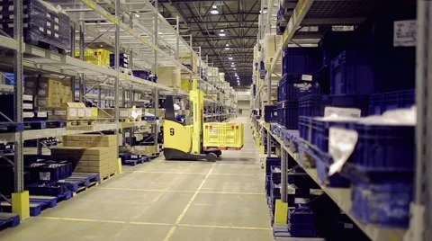 Man driving forklift and loading cargo on rack in warehouse Stock Footage 61123336