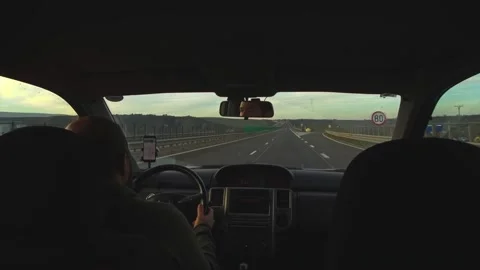 Man driving on highway at sunset Stock Footage 224064976