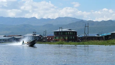 A man driving his boat on floating burmese gardens, Asia in HD Slow motion Stock Footage 95199807