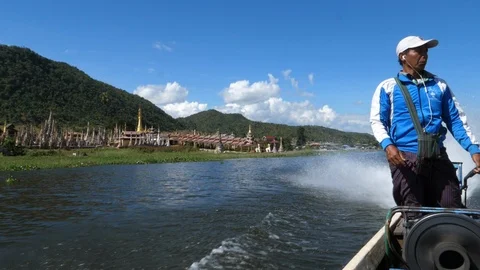 A man driving his boat on floating burmese gardens, Asia in HD Slow motion Stock Footage 95213388