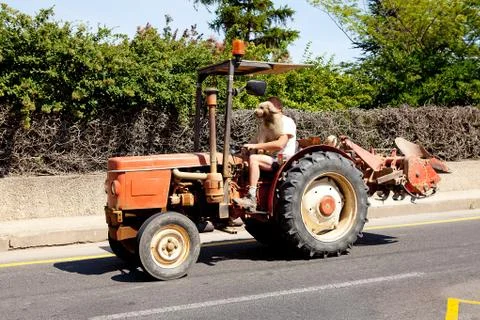 Man is driving his tractor Stock Photos