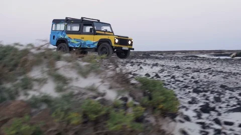 Man driving jeep on the beach Stock Footage 71829403
