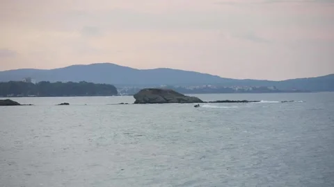 Man driving jet ski during sunset Stock Footage 143938599
