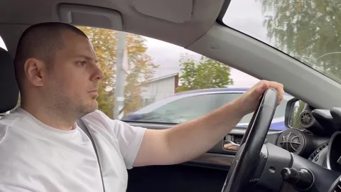 Man driving, a man behind the wheel on a sunny summer day, enjoying a caref.. Stock Footage 252021014