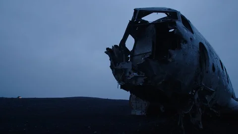 Man driving a quad to a wrecked plane on an Iceland beach Stock Footage 104240682