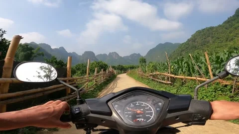 Man is driving scooter. Stunning views in Cao Bang, Vietnam Stock Footage 321109571