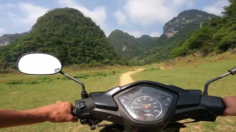 Man is driving scooter. Stunning views in Cao Bang, Vietnam Stock Footage 321109575