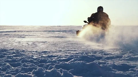 Man driving snowmobile in cold winter Stock Footage 77351180
