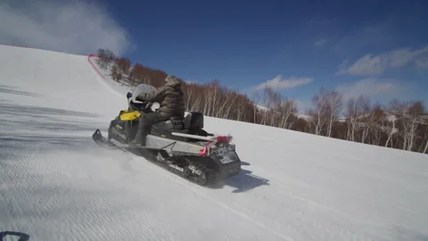 Man driving a snowmobile speeding in a ski resort,Zhangjiakou, China Stock-Footage 135235105