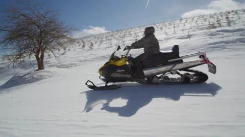 Man driving a snowmobile speeding in a ski resort,Zhangjiakou, China Stock Footage 135242249
