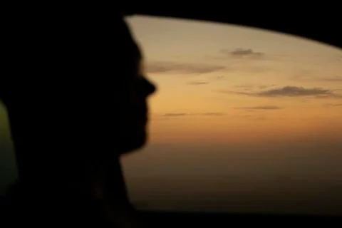 Man is driving into the sunset Stock Photos