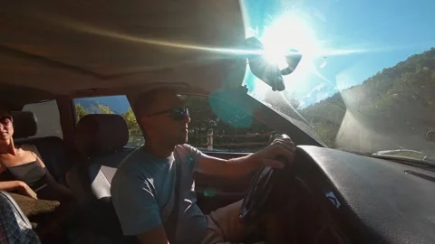Man driving through scenic mountain road in bright sunlight Stock Footage 301697085