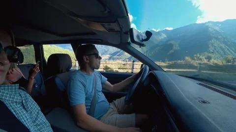 Man driving through scenic mountain road in bright sunlight Stock Footage 301697237