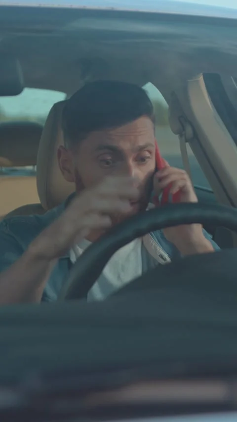 A man driving a vehicle while using his phone shows the risks of distracted Stock Footage 314959279