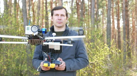 Man drone operator  operate by copter  with camera. 4K 3840x2160 Stockbeeldmateriaal 49058452