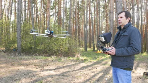 Man drone operator  operate by copter in sunny wood. 4K 3840x2160 库存影片 49059075