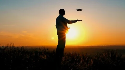 Man with drone at sunrise Stock Footage 120755672