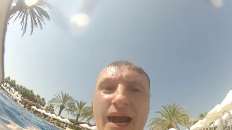 Man drop smartphone under water at poolside, dive and catch it Video stock 82077386