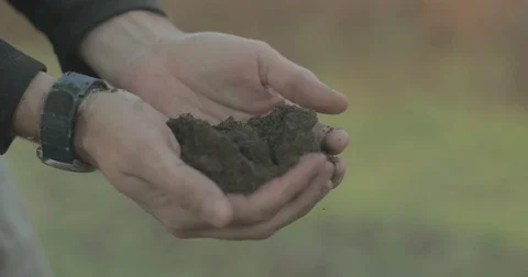 Man dropping dirt from hands Stock Footage 76405377