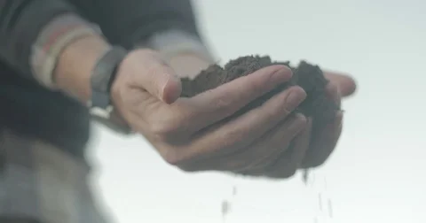 Man dropping dirt from hands Stock Footage 76405413