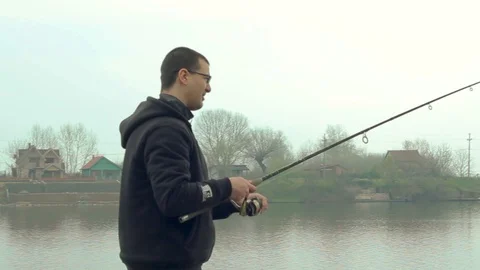Man dropping fish rod in water Stock Footage 89775322
