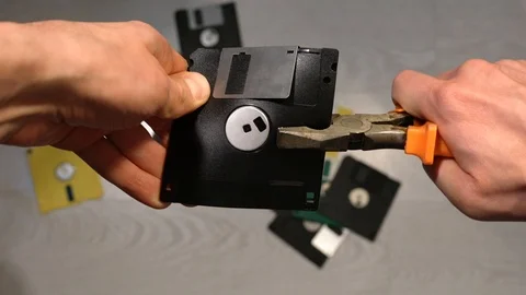 Man is dropping an old diskette Stock Footage 121534868