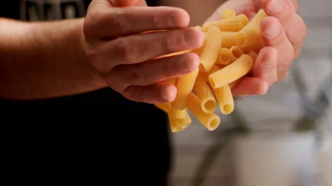Man dropping pasta for cooking Stock Footage 156787234
